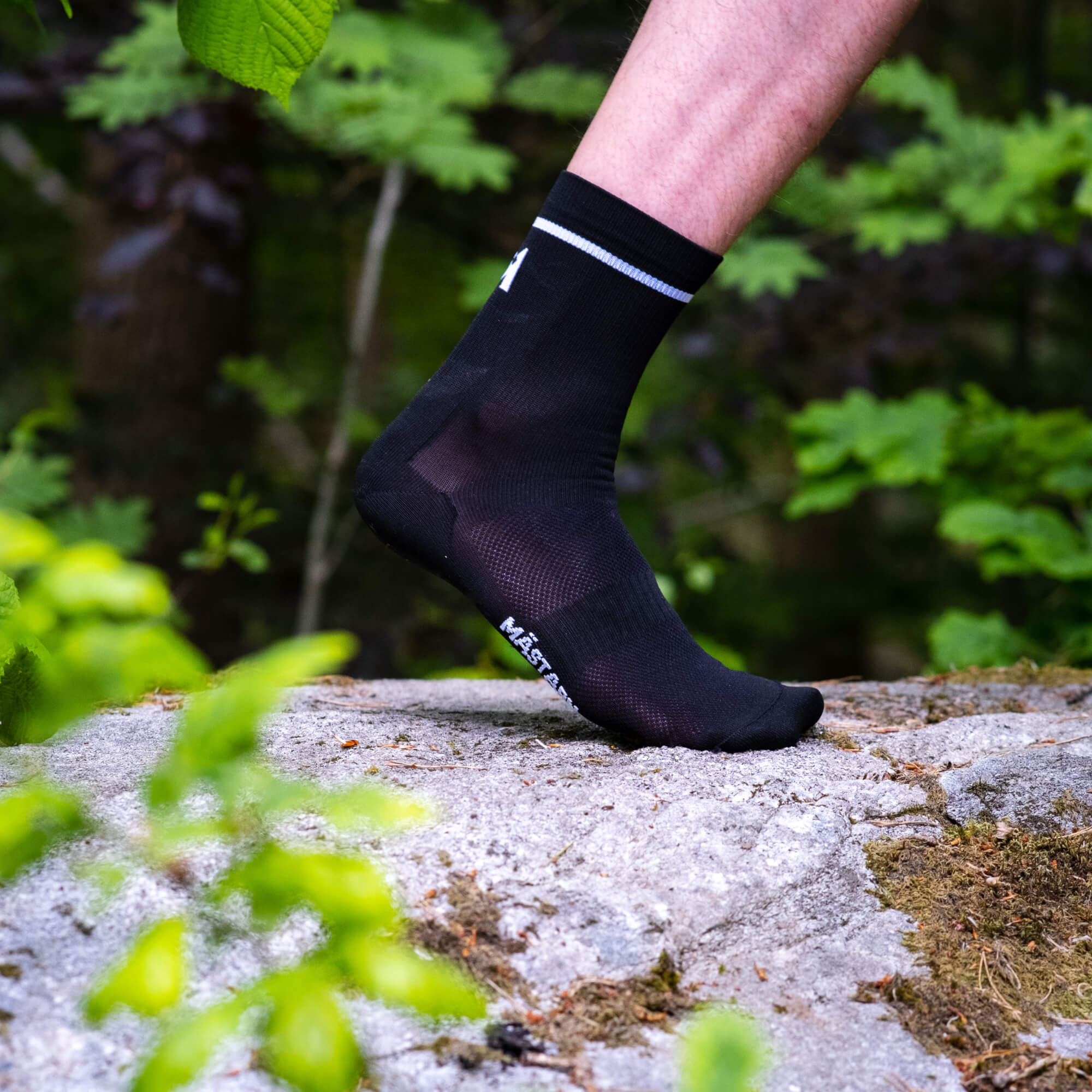 Dryarn® Race Liner i svart buren på foten, närbild på stenen