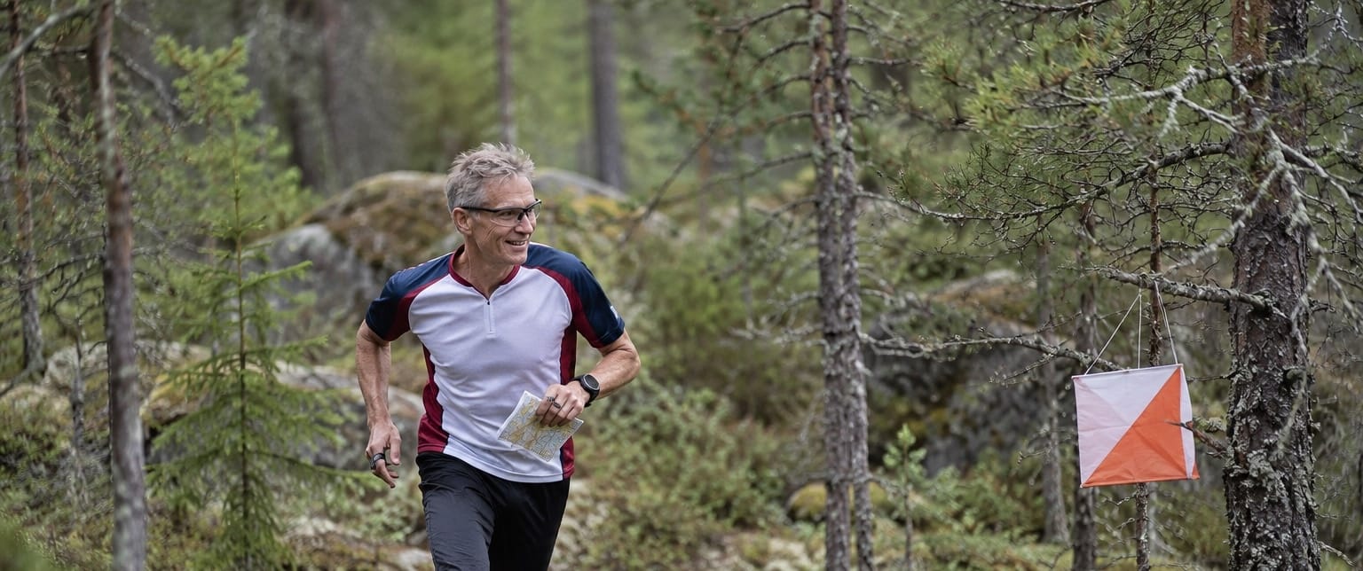 A person running orienteering while wearing glasses